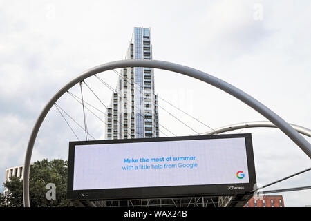 Electronic billboard message 'Make the most of summer with a little help from Google ' & grey sky at Old Street Roundabout in London Tech City UK Stock Photo