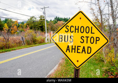 School bus stop ahead Warning road sign on a cloudy autumn day. Back to school concept. Stock Photo