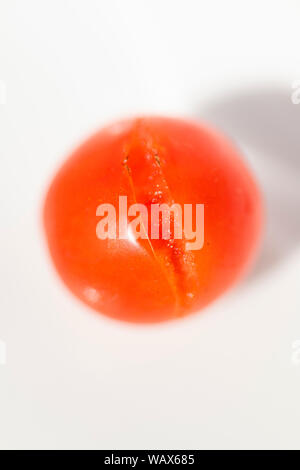 Split cherry tomato on a white background Stock Photo