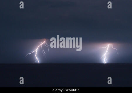 Two branched lightning strikes over the Adriatic Sea near the coast of Croatia