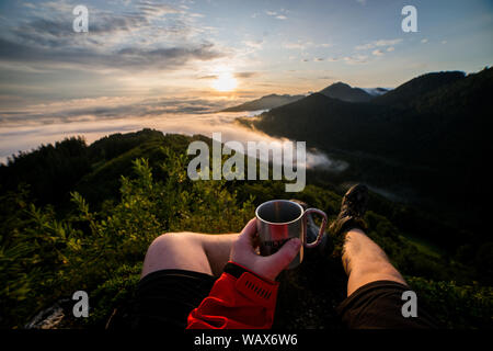 First person view of drink coffee in the mountains Stock Photo