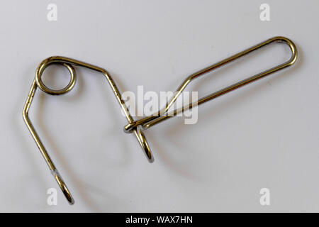 Overhead view of a wire third hand tool used to pull bicycle brakes together in order to adjust them, isolated on a plain background Stock Photo