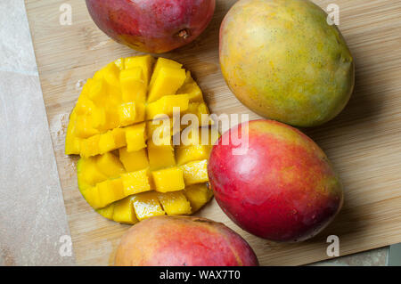 Top view of fresh mango on a wooden cutting board Stock Photo