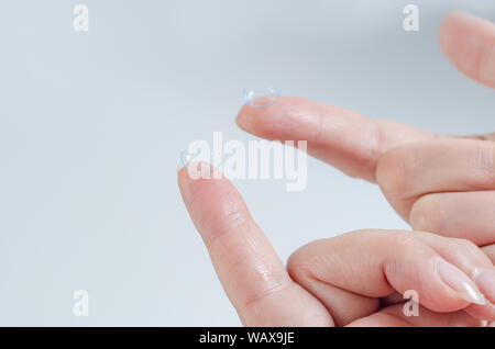 Contact lens close-up on a woman’s fingertip. Good vision, optometrist, treatment. Stock Photo