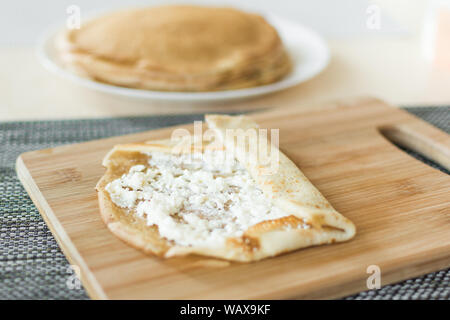 Traditional russian pancakes staffed with cottage cheese Thin homemade pancakes with crispy crust. Maslenitsa holiday. Stock Photo