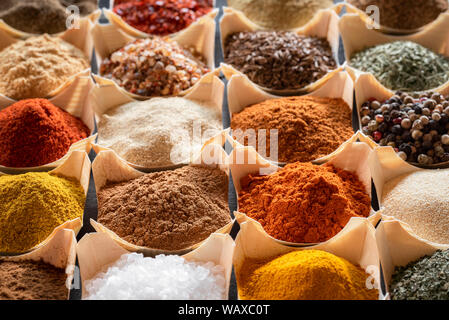 Different kinds of spices close-up image. Condiments and flavors in bowls in a  pattern. Herbs and Indian spices background. Stock Photo