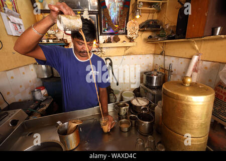 Tea wallah preparing tea in a small traditional stall in Madurai, India. Stock Photo