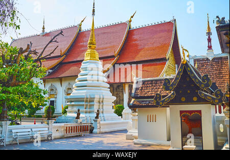 The carved white-gilt chedi located next to Sao Inthakin and Phra Viharn Luang (Main Hall) of Wat Chedi Luang, Chiang Mai, Thailand Stock Photo