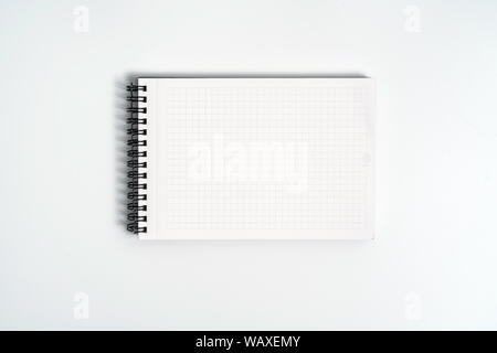 Notebook mock up with clean black blank for design and advertising. Notepad with chromed spring and free copy space template. On the gray background. Stock Photo