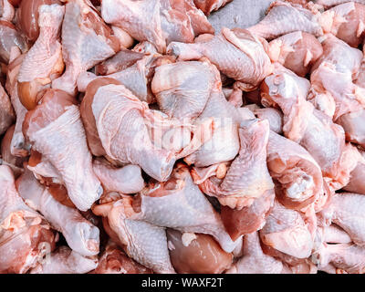 Large Pile of Raw fresh Chicken Drumstick or chicken legs top view shot - Wholesale meat product in market Stock Photo