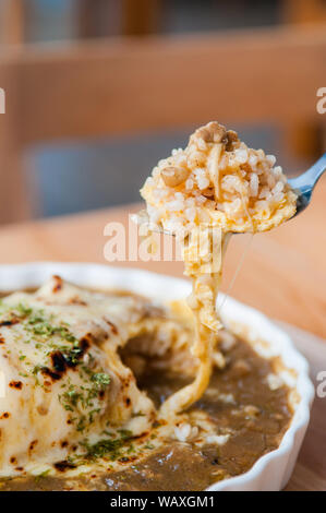 Japanese Kare Omu rice, Japanese omelette rice with curry on spoon Stock Photo