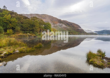 Looking east along Llyn Dinas on a misty morning in the Gwynant valley near Beddgelert Snowdonia National Park North Wales UK October 2018 Stock Photo