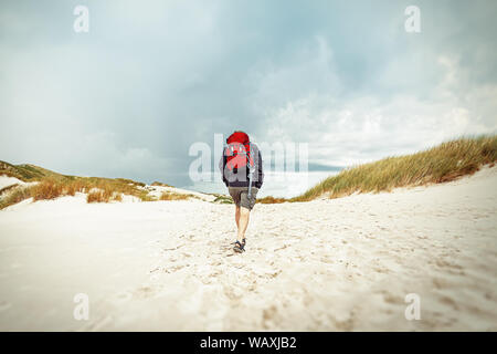 Man walking in the sand, Island Amrum Stock Photo