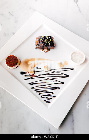 Fried Foie gras with sweet and sour balsamic sauce, pear sauce and cookie Stock Photo