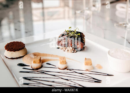 Fried Foie gras with sweet and sour balsamic sauce, pear sauce and cookie Stock Photo