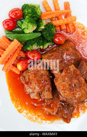 Pot roasted por ribs with tomato base sauce. Stock Photo
