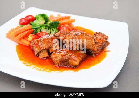 Pot roasted por ribs with tomato base sauce. Stock Photo