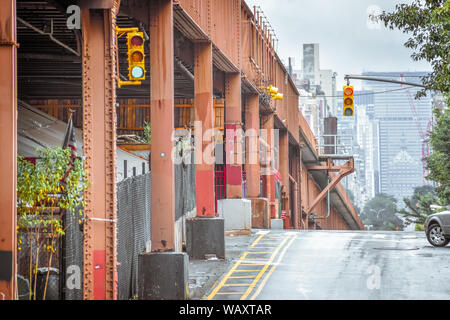 Bottom view of Elevated train track nyc. Buildings in the background in a foggy day. NYC, USA. Stock Photo