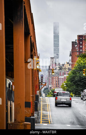 Bottom view of Elevated train track nyc. Buildings in the background in a foggy day. NYC, USA. Stock Photo