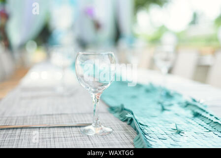 outdoor lunch in the sun. Laid blue table with wine glasses. Stock Photo