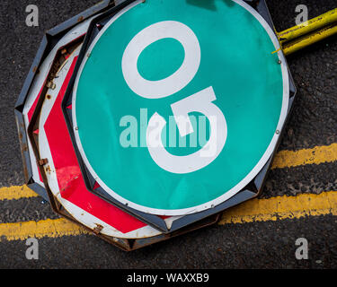 Stop Go Roadwork Signs left on the roadside. Stop and Go Lollipop Signs Stock Photo