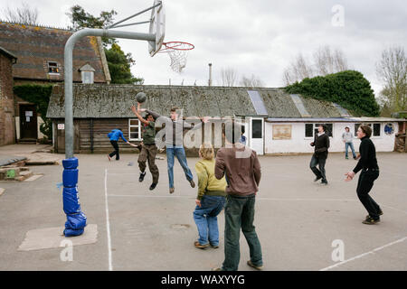 Pupils playing basketball in the playground at the Waldorf Steiner School in Hereford, UK Stock Photo