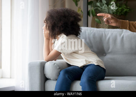 Stubborn offended African American girl daughter ignoring angry father Stock Photo