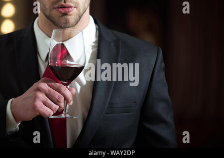 man hold wine glass, bearded guy in office style clothes at restaurant,  sommelier near woman in mirror Stock Photo - Alamy