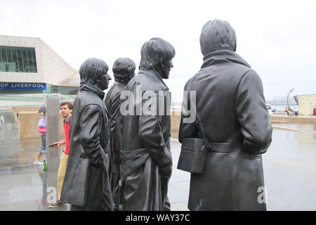 Sculpture of the Beatles on Pier Head, Liverpool Docks, Merseyside, in rainy weather. Installed in 2015. Artist: Andy Edwards. North-western Europe. Stock Photo