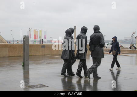 Sculpture of the Beatles on Pier Head, Liverpool Docks, Merseyside, in rainy weather. Installed in 2015. Artist: Andy Edwards. North-western Europe. Stock Photo