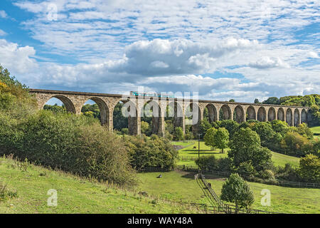 Train crossing the viaduct over the River Dee in the Vale of Llangollen with Ty Mawr Country Park in the foreground North Wales UK September 2018 0236 Stock Photo