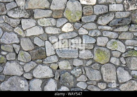 Big wall made from curved grey stones Stock Photo