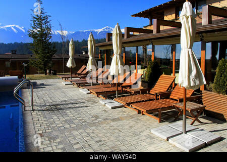 Resort terrace with swimming pool and sunny lounges Stock Photo