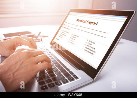 Man Filling Patient Information Form On Digital Laptop Stock Photo