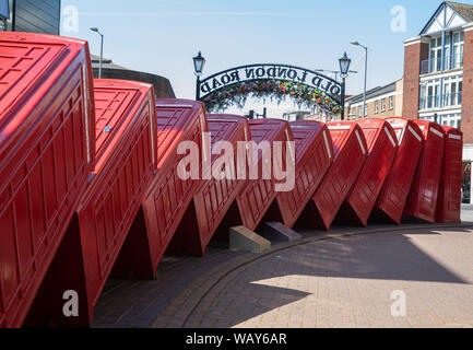 12 telephone boxes toppled over like dominoes is symbolic of Kingston Upon Thames, Surrey. Out of Order, by David Mach, arrived in 1989. Stock Photo