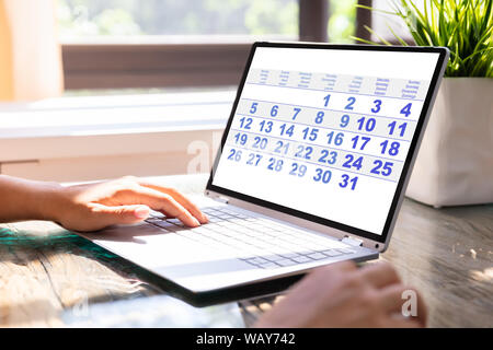 Close-up Of A Business Person Looking At Calendar On Laptop Computer Stock Photo