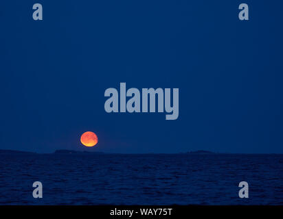 Moonrise over Baltic Sea in Southern Finland on early summer night in August Stock Photo
