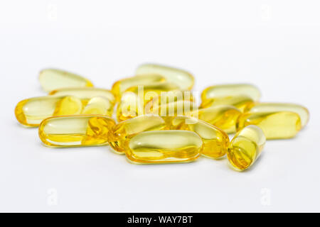vitamin pills or gel capsules on white background Stock Photo