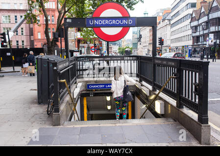 London, UK - August  2019: Woman entering London Underground at the Chancery Lane station street level Stock Photo