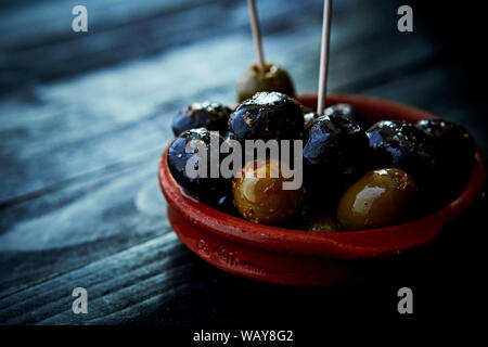 Olives, close up, in a Tapas-Cup at a Tapas restaurant Stock Photo