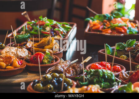 Various tapas cups and salads on a table at a Tapas Bar Stock Photo