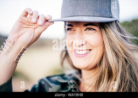 Pretty blonde woman with cap posing at camera Stock Photo