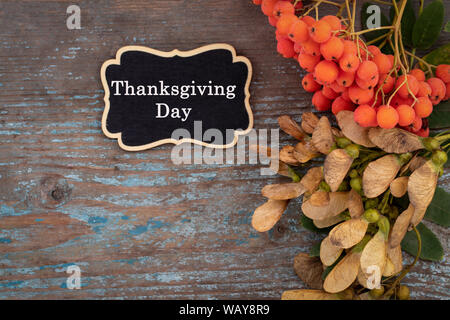 Autumn background from fallen leaves and fruits with vintage place setting on old wooden table. Thanksgiving day concept. Stock Photo