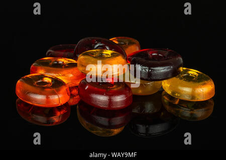 Lot of whole colourful hard candy isolated on black glass Stock Photo