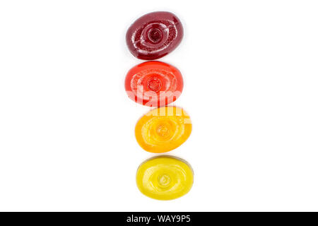 Group of four whole colourful hard candy in line flatlay isolated on white background Stock Photo