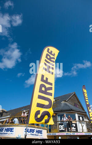 A brightly coloured banner advertising the Surf Hire equipment in Newquay in Cornwall. Stock Photo