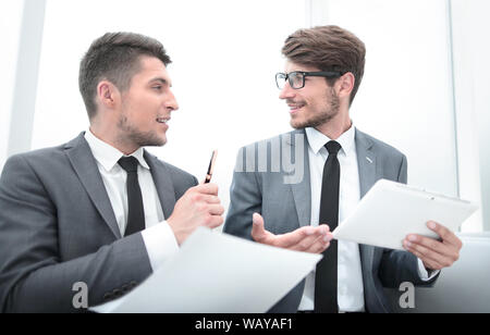 young businesspeople looking at each other and talking at the office Stock Photo
