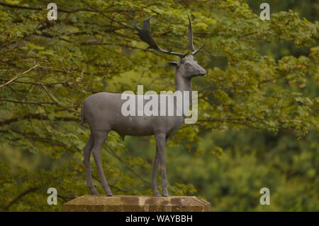 A statue of a roe deer stag on a granite plinth. One of a pair in the deer park on the Haddo Estate, Aberdeenshire, Scotland. Stock Photo