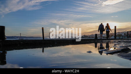 Couple walking near Tejo river in Lisbon Stock Photo