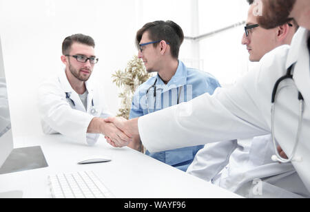 handshake between the two doctors during the working meeting Stock Photo